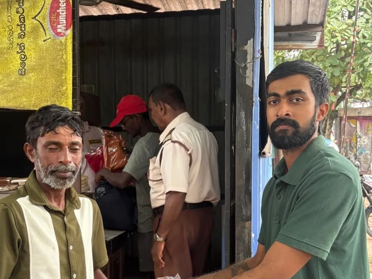 A Leo handing a bag of clothes to a council worker