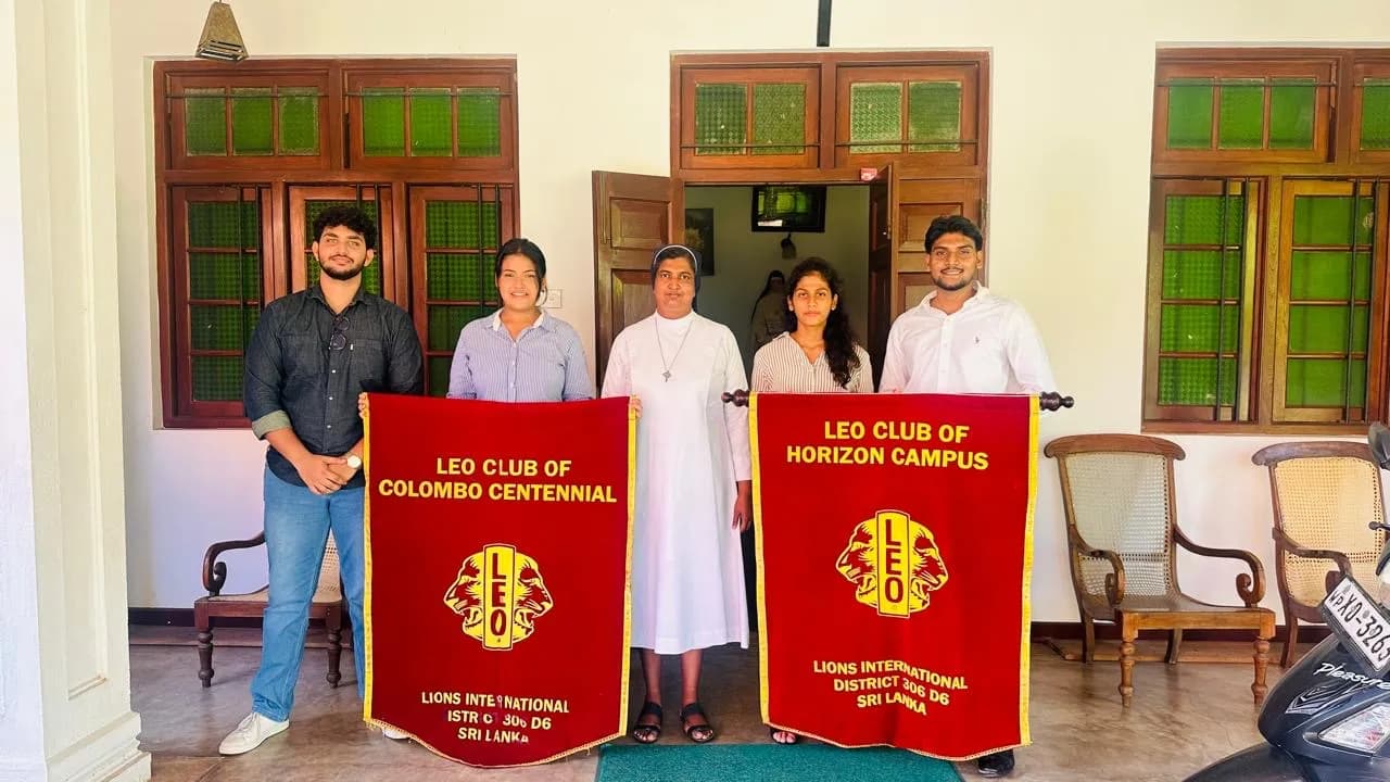 Leos and a sister of the convent holding club banners