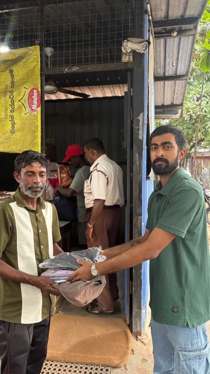A Leo handing a bag of clothes to a council worker